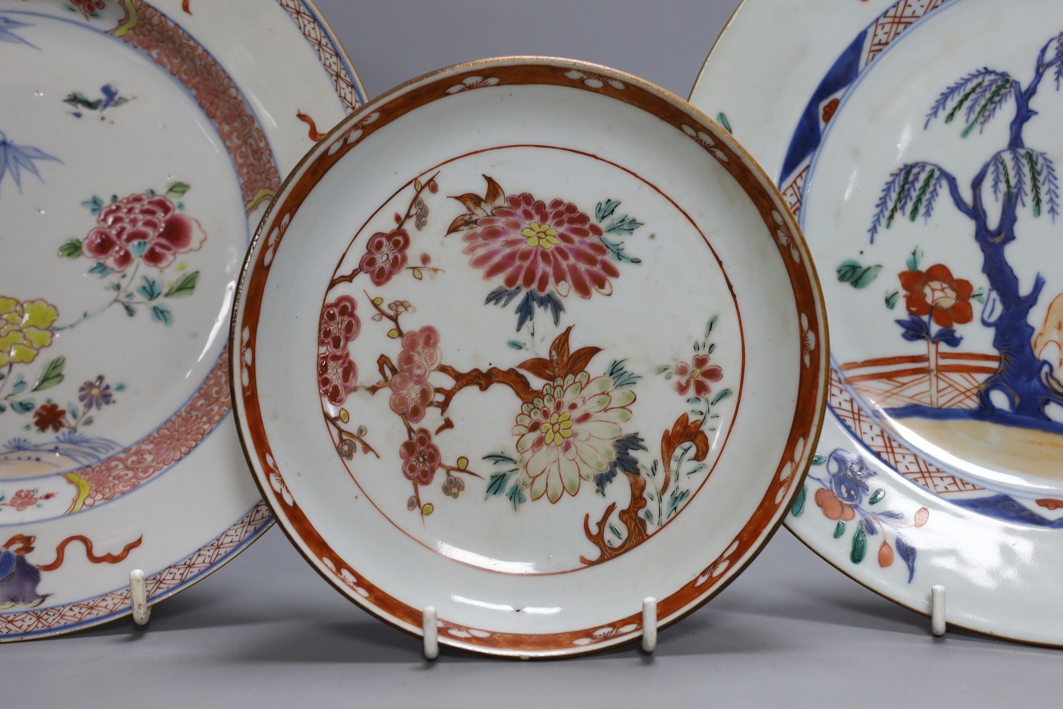 An 18th century Chinese export famille rose plate, similar saucer and an 18th century Chinese vert Imari plate, largest 22.5cm